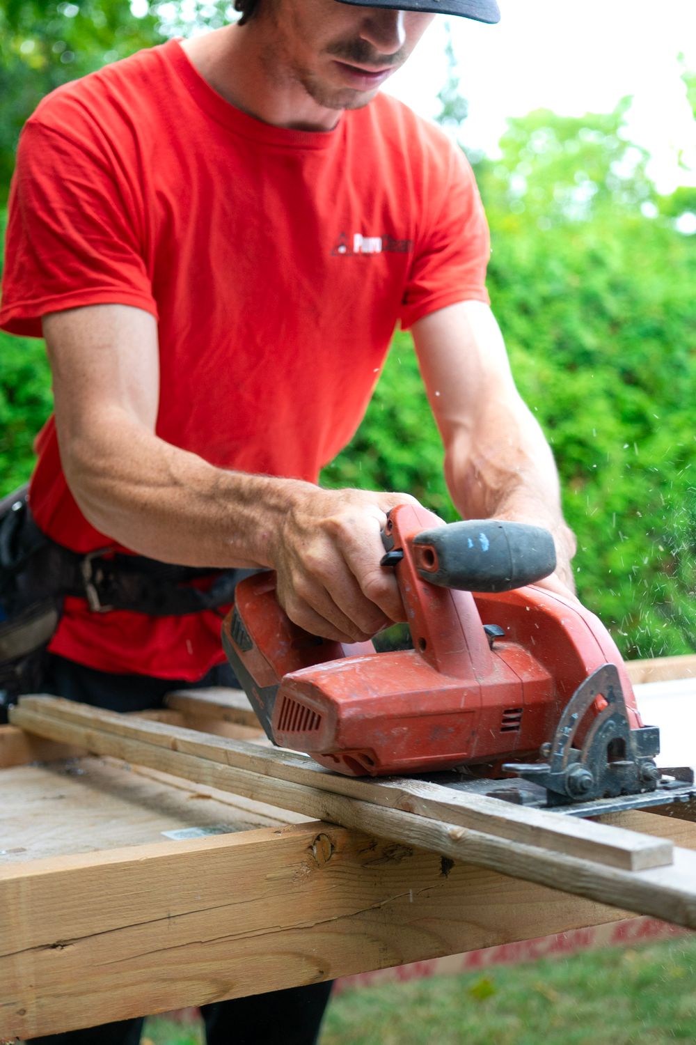 Carpenter cutting lumber with a circular saw